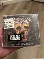 Front of sealed Aerosmith Devil's Got A New Disguise CD in jewel case