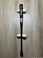 Full view of signed World Win bat with wall mounts attached