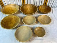 Top view of all eight bowls showing size range and wood finish