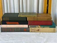 All nine books stacked showing spines