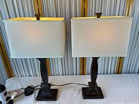 Front view of both table lamps showing bases, shades, cords