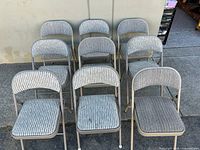 Front view of all nine folding chairs showing upholstery and frames