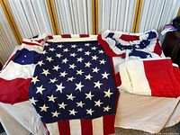 Flag and bunting laid out showing stars, stripes, pleats