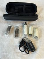 Entire kit showing case, five sealed components and charger