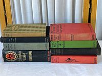 Both stacks of nine hardcover books showing spines and colours