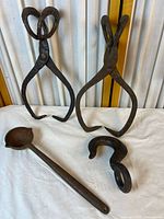 Group shot of ladle, two pivoting hooks, spiral hook