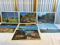 All seven 12x18 inch glossy prints displayed on table