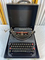Typewriter in open case showing overall condition