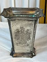 Full view of silver-plated vase showing shape, rim and base