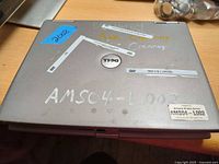 Top lid with Dell logo, asset stickers, scuffs