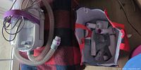 Vacuum unit on blanket, hose, bag with attachments