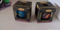 Two boxed Le Vitrage glowing glass candles