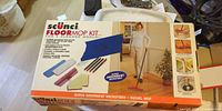 Front of boxed scünci microfiber swivel floor mop kit showing contents and bilingual text