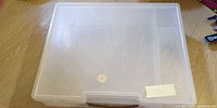 Closed translucent storage bin showing frosted lid and carry handle
