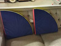 Two Foamnasium triangular mats on sofa showing shape and blue surface