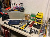 Wide shot of entire lot on table including tote, chemicals, antifreeze, wipers, first aid kit and accessories