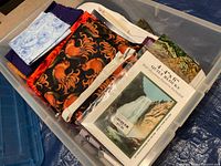 Fabric pieces, quilt book, pattern pack arranged in clear bin