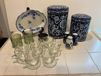 Group view of all items: two canisters, serving bowl, eight glass cups, two green tumblers, three shakers