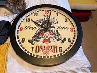 Front of Duluth Trading wall clock showing face and graphics