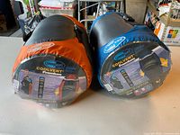 Front view of both SleepCell CoolVent Premium sleeping bags in their compression sacks showing brand and model labels