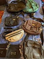 Overview of seven assorted bags on tarp