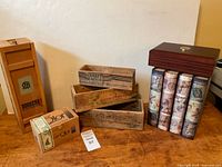 Group shot of all boxes including cheese crates, decorative book boxes, whiskey box, cigar box