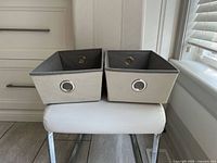 Front view of both fabric bins showing exterior color and grommet handles