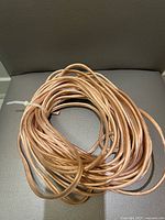 Coiled clear jacket copper audio cable on chair