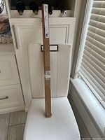 Full boxed shower rod on chair