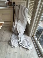 Grey blackout drapes pooled on floor