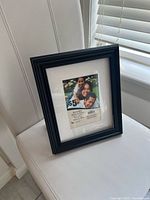 Black picture frame showing front view with sample photo and size information
