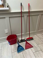 Group shot of bucket, two long-handle tools, two dustpans