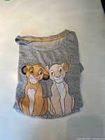 Folded heather grey women’s nightshirt showing Simba and Nala graphic