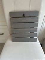 Front view of grey wooden slat clipboard showing metal clip