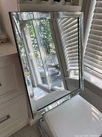 Front view showing rectangular mirror with beveled mirrored frame