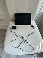 Front view of Dynex digital picture frame with power adapter