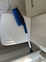 Blue bristle snow brush and scraper showing overall design