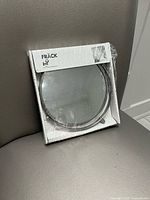 Front of sealed IKEA Fräck mirror box showing product and brand