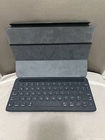 Apple Smart Keyboard open, showing keys and folding cover