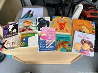 All twelve children’s books laid out on tabletop