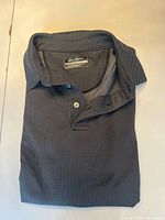 Folded Ben Hogan golf polo showing overall design and color