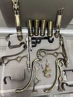 Close view of mixed curtain hardware laid out on chair