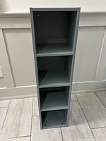 Front view showing four shelves and gray finish