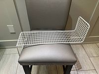 Shelf laid horizontally on chair showing overall L shape and grid construction