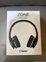Front of sealed retail box showing image of black Phaiser Zone BHS-630 headphones