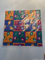 Front view of sealed wrapping paper pack showing full pattern