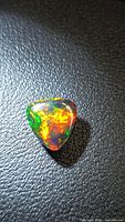 Trillion cabochon Ethiopian black opal showing multicolored fire