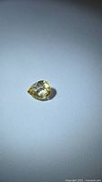 Pear cut yellow sapphire on neutral background