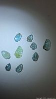 Group of nine carved Paraiba blue tourmaline gemstones