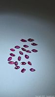 Group of small marquise rubies on neutral background